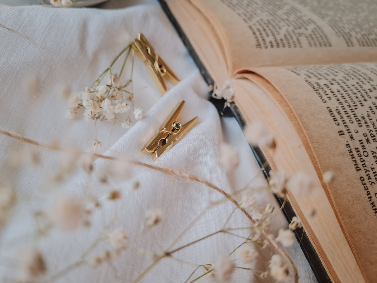 Gold and Silver Cross Pendant Necklace on White Textile